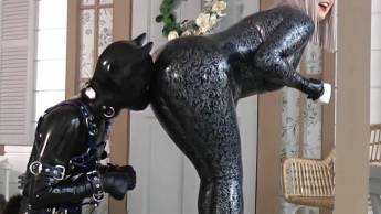 Domina Arya Grander in latex playing with her rubber dog. Femdom.