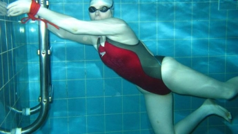 Gagged and bounded underwater in red Fastskin suit