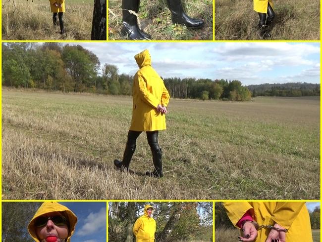 Handcuffed walk with ball gag and in yellow raincoat