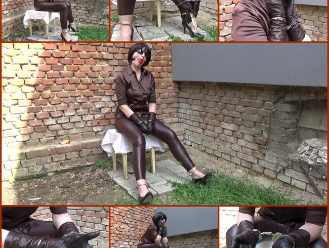 Angela handcuffed in brown leather leggings and gloves